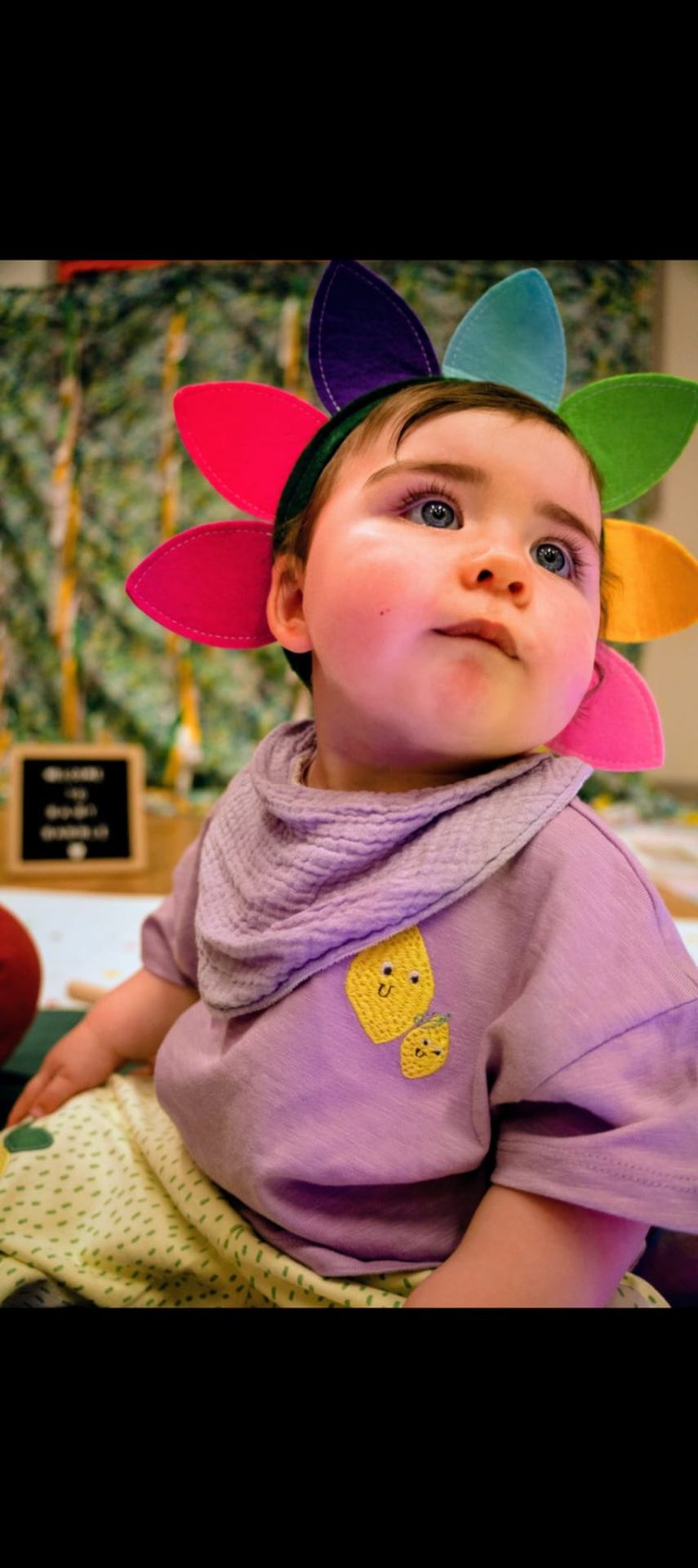 Baby Annie wearing a colourful rainbow flower crown at a Baby Babble NI Explorer class